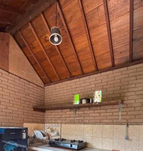 a kitchen with a stove and a ceiling at Santika Guest House in Ubud