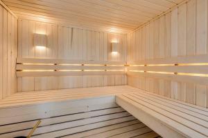a sauna with wood paneling and lights in it at Executive Acreage 3 King Beds Fireplace AC in Airdrie