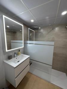 a white bathroom with a sink and a shower at Calma Suite Apartment - Mar Menor Golf Resort in Torre-Pacheco
