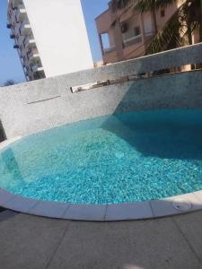 a pool with blue water in front of a building at F3 ngor virage in Dakar
