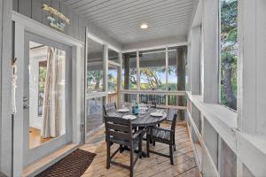 a dining room with a table and chairs on a porch at SS3512: 3512 Seascape in Kiawah Island