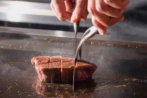 a person is eating a piece of bread with a fork at NISEKO Inn of Youtei Raku Suisan in Kutchan +32 photos