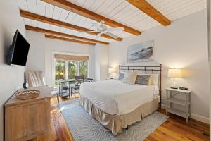 a bedroom with a bed and a table with chairs at SS3510: 3510 Seascape in Kiawah Island