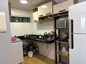 a kitchen with a counter and a refrigerator at Apartamento Com Piscina prox a BR in Ananindeua