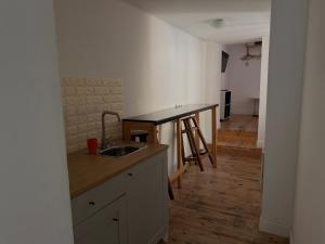 a kitchen with a sink and a counter top at Belle Art Hotel in Odesa