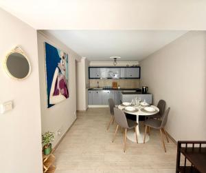 a dining room and kitchen with a table and chairs at SEA LEVEL Sopot in Sopot +22 photos
