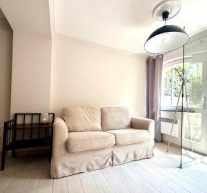 a living room with a couch and a window at SEA LEVEL Sopot in Sopot