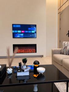 a living room with a couch and a fireplace at مساكن لينا الفندقية in Abha