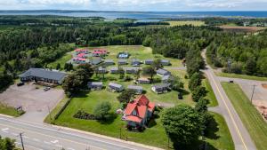 an aerial view of a village with a house and a road at Cavendish Lodge & Cottages in Cavendish