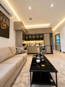 a living room with a couch and a table at مساكن لينا الفندقية in Abha +3 photos