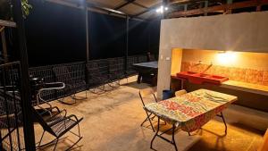 a table and chairs in a room with a table and a table and a table at Brisas Griegas in Quepos