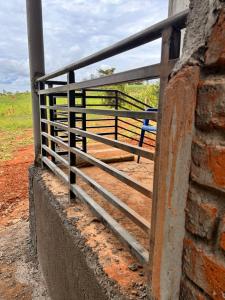 a fence on the side of a brick wall at Shan in Jinja