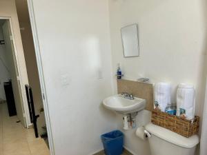a white bathroom with a sink and a toilet at Casa Morelia ideal, rest or work in San Carlos +60 photos