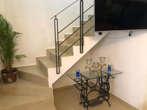 a staircase with a tv and a glass table at Casa Morelia ideal, rest or work in San Carlos