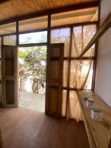 a room with a large door and a window at Negritos Beach House in Negritos