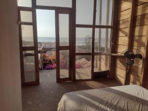 a bedroom with an open window with a view at Negritos Beach House in Negritos +27 photos