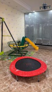 a childrens play area with a trampoline and a playground at شقق فندقيه in Buraydah