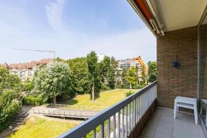 a balcony with a view of a park at Malgré Tout 0312 in Koksijde