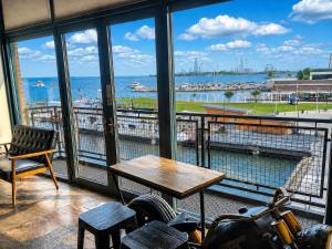 a room with a table and a view of a harbor at Mario Room Waterfront Downtown View Cedar Point! in Sandusky
