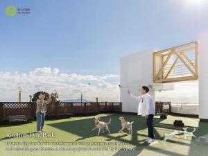 two people and two dogs playing with a frisbee at YU-FURI Izukogen in Ito