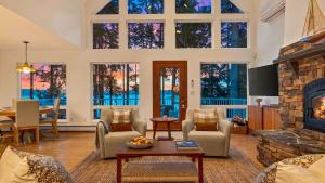 a large living room with a fireplace and a table at Eagles Bluff by AvantStay in Greenbank