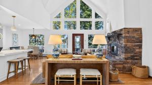 a kitchen and living room with a stone fireplace at Eagles Bluff by AvantStay in Greenbank
