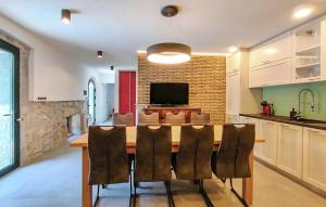 a kitchen and dining room with a table and chairs at Amazing Home In Lanisce in Lanišće