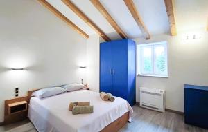 a bedroom with a large bed and a blue cabinet at Amazing Home In Lanisce in Lanišće