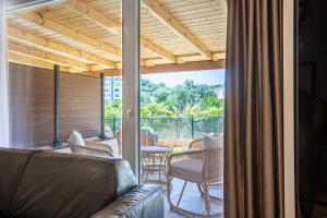 a living room with a couch and chairs on a patio at AMA'S Duplex 5 - Parking, Kitchen, Central in Himare