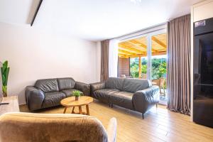 a living room with a couch and a table at AMA'S Duplex 5 - Parking, Kitchen, Central in Himare