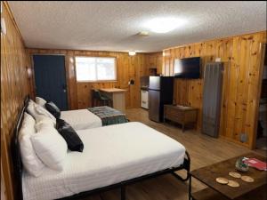 a hotel room with two beds and a kitchen at Bellamy's Ski Haus in Red River