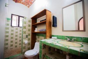 a bathroom with a sink and a toilet and a mirror at Casa Carmela in Sayulita +63 photos