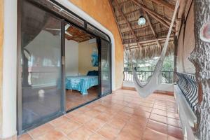a porch with a hammock in a house at Casa Carmela in Sayulita