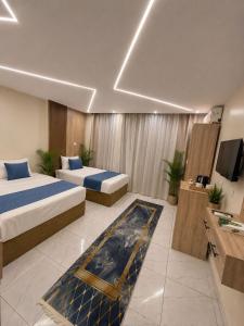 a hotel room with two beds and a television at Leeda Pyramids View in Cairo