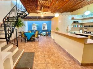 a kitchen and dining room with a blue table and chairs at Casa Carmela in Sayulita