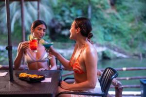 two women sitting at a table with drinks at Hotel Termales Espiritu Santo in Nariño +75 photos