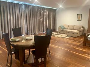 a dining room with a table and chairs and a couch at Your SHACK by the water in Sorell