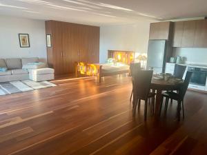 a kitchen and living room with a table and a couch at Your SHACK by the water in Sorell