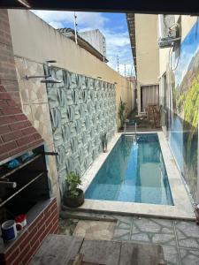 a swimming pool on the side of a building at Casa para Pedrão in Eunápolis