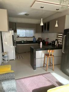 a kitchen with a refrigerator and a counter top at Casa para Pedrão in Eunápolis