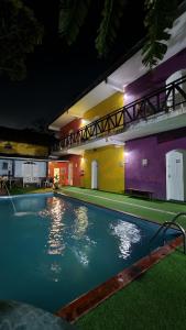 a swimming pool in a house at night at Pousada Morada do Tombo in Guarujá