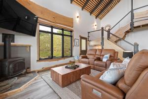 a living room with leather furniture and a fireplace at The Bald Doe in Sturgis