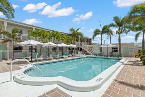 a swimming pool at a resort with palm trees at Hotel Cabana Clearwater Beach in Clearwater Beach