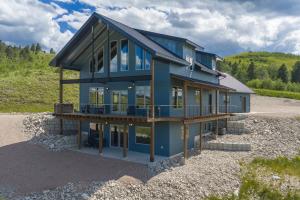a blue house with a lot of windows at The Bald Doe in Sturgis