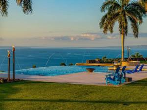 a swimming pool with a view of the ocean at Villa with pool extraordinary view in Lahaina in Lahaina