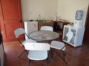 a kitchen with a table and chairs in a kitchen at Cabañas Pakaia in Hanga Roa