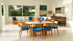 a living room with a table and chairs at NEW! 3BR Ocean View, Infinity Pool, Villa Helios in Sampalan