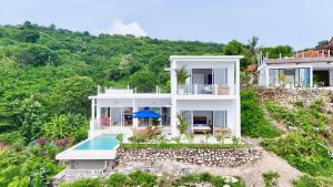 an aerial view of a house with a swimming pool at NEW! 3BR Ocean View, Infinity Pool, Villa Helios in Sampalan