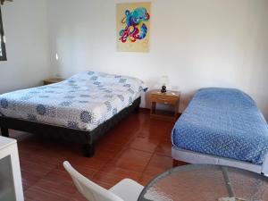 a room with two beds and a glass table at Cabañas Pakaia in Hanga Roa