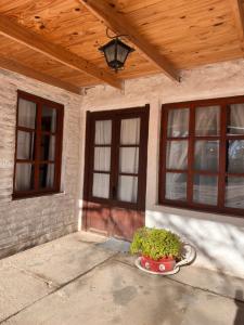 a porch of a house with windows and a potted plant at Functional Department in Colorado River +3 photos